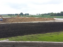 Leveling the sand inside and the dirt outside the foundation