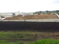 Leveling the sand inside and the dirt outside the foundation